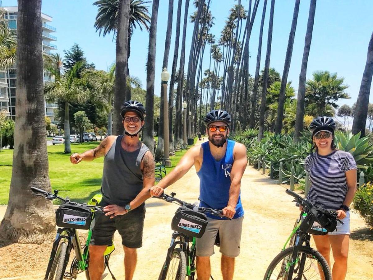 a group of people riding on the back of a bicycle
