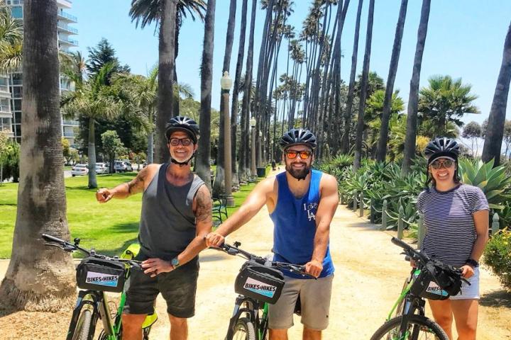 a group of people riding on the back of a bicycle