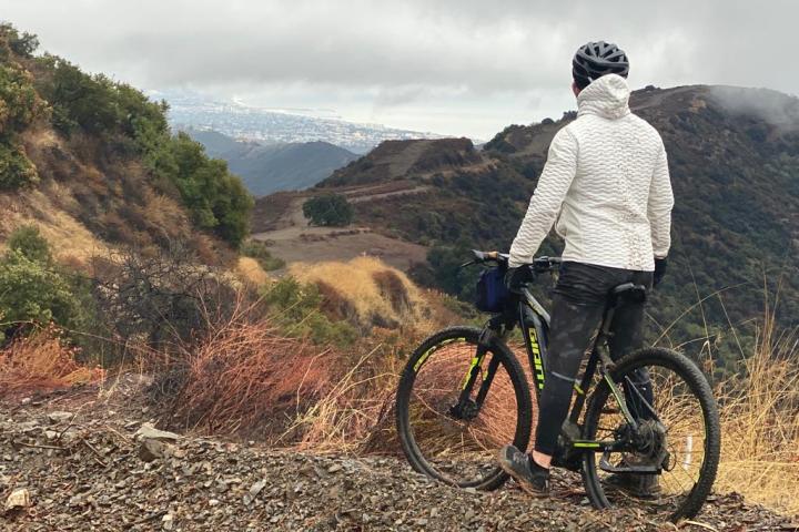 a man riding a bike down a dirt road