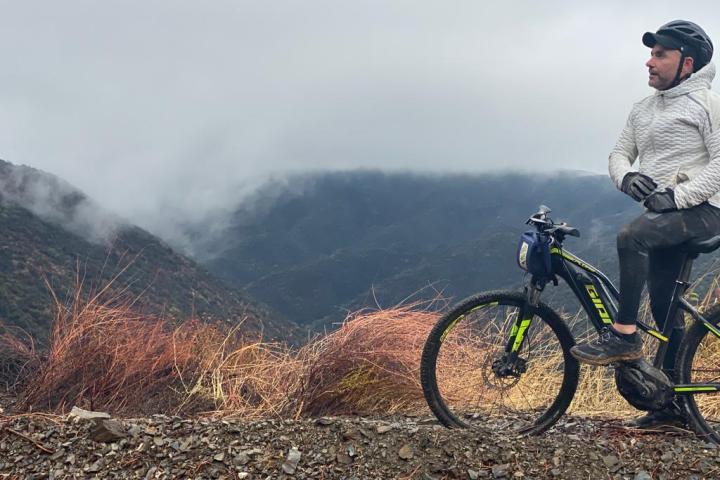 a man riding a bike down a dirt road