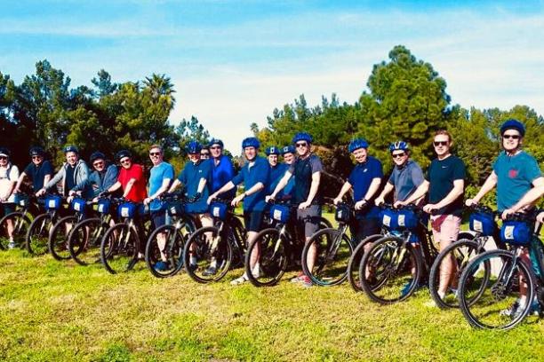 a group of people standing around a motorcycle