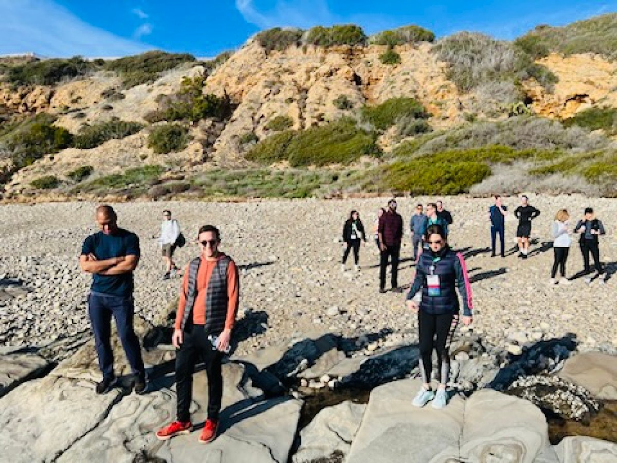 a group of people standing on top of a mountain
