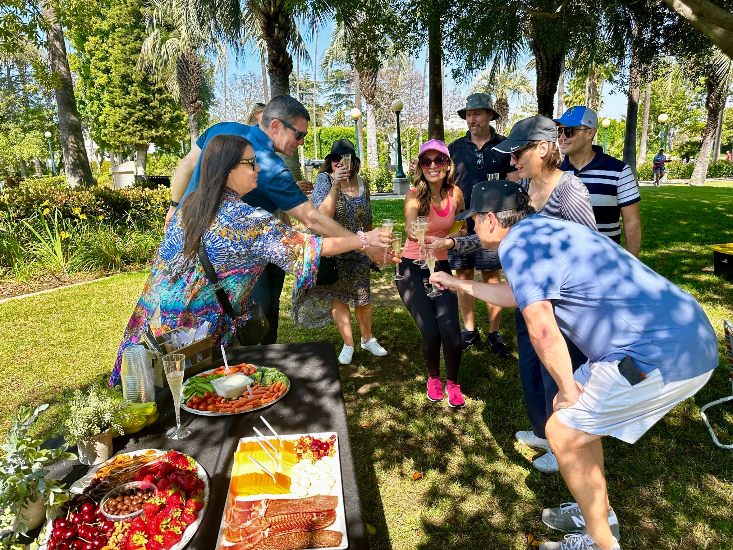 a group of people toasting in a park