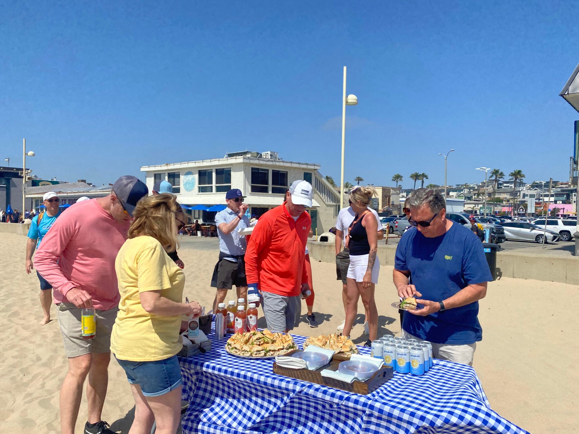 a group of people standing in front of a food table