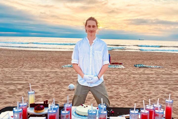 a man standing in front of a beach
