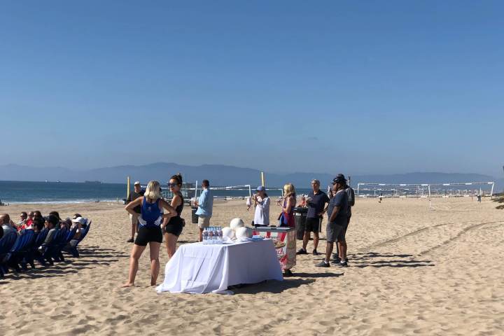 group on beach enjoying games & water