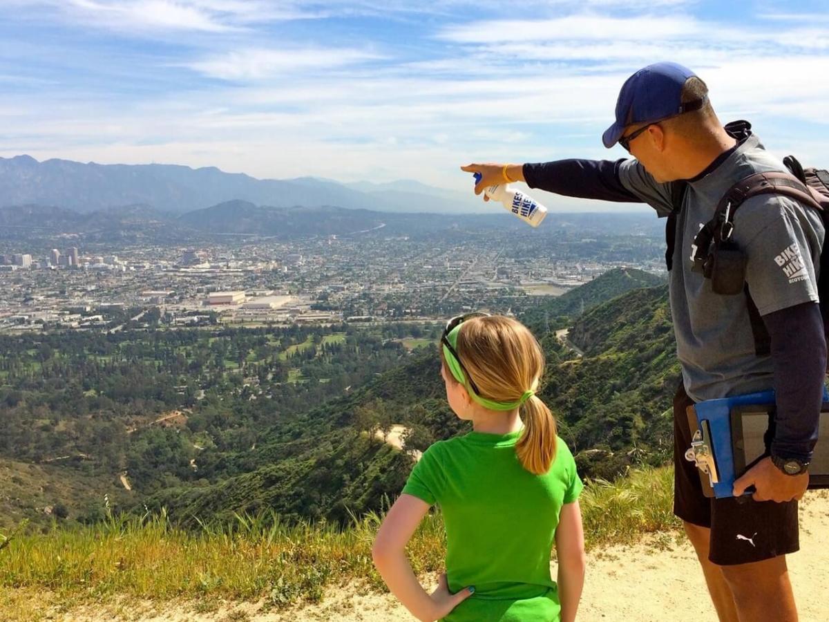 man with daughter on hike