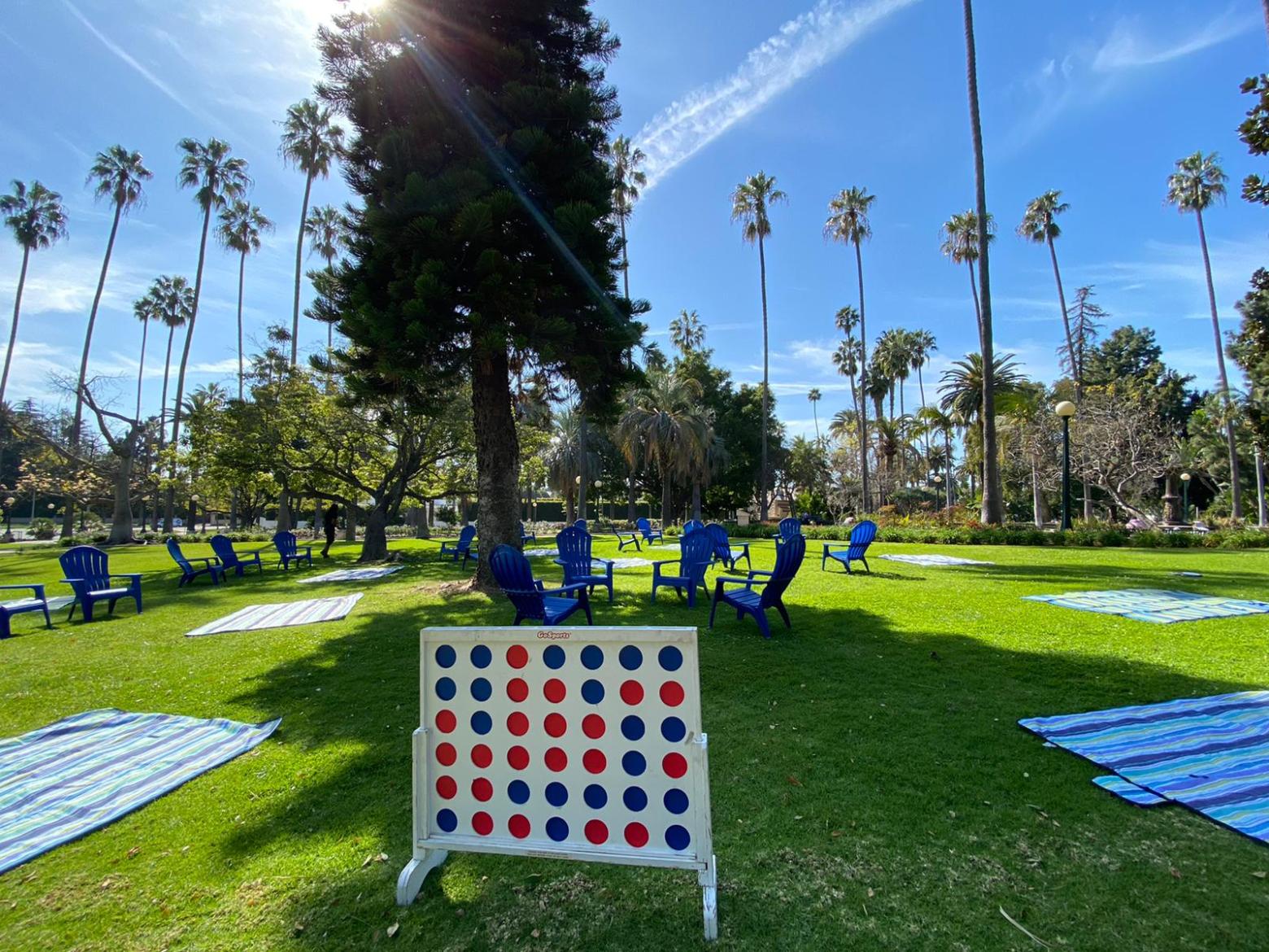 a group of lawn chairs sitting on top of a grass covered field