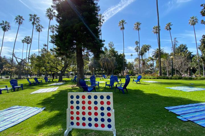 a group of lawn chairs sitting on top of a grass covered field