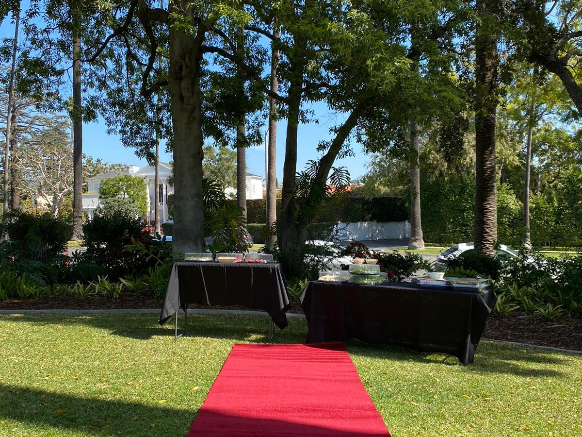 a couple of lawn chairs sitting on top of a grass covered field
