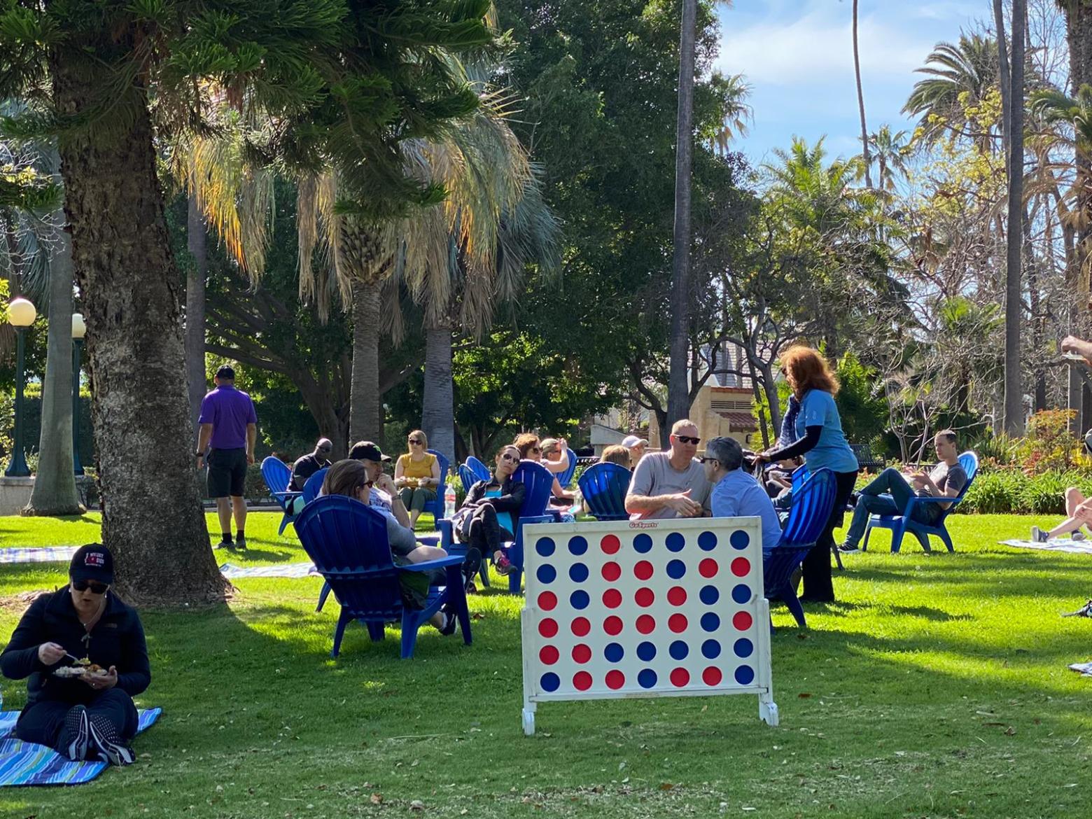 a group of people sitting at a park
