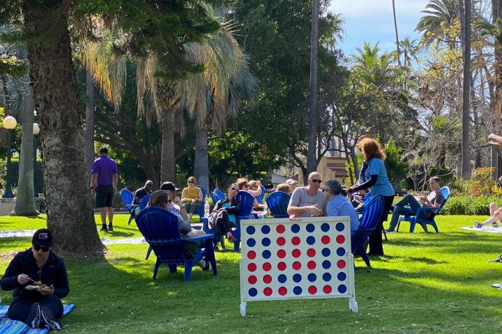 a group of people sitting at a park