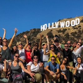 a group of people standing in front of a crowd posing for the camera