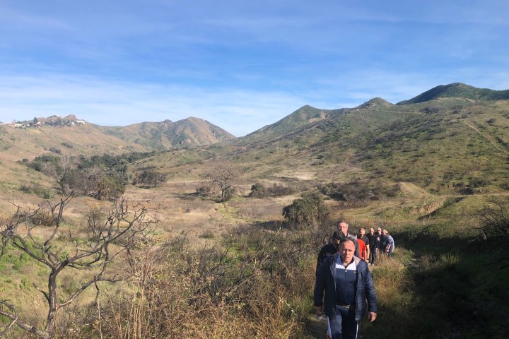 a man standing in front of a mountain