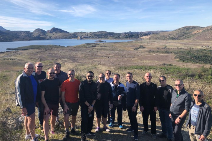 a group of people standing in front of a crowd posing for the camera