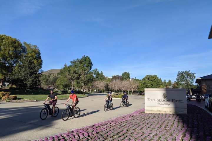 a group of people riding on the back of a motorcycle
