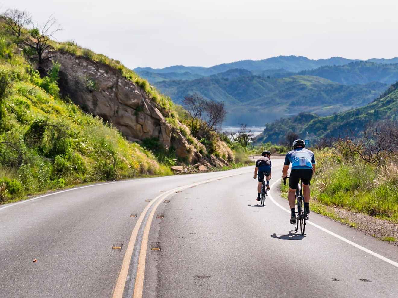 a man riding a skateboard down the side of a mountain road