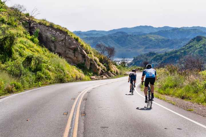 a man riding a skateboard down the side of a mountain road