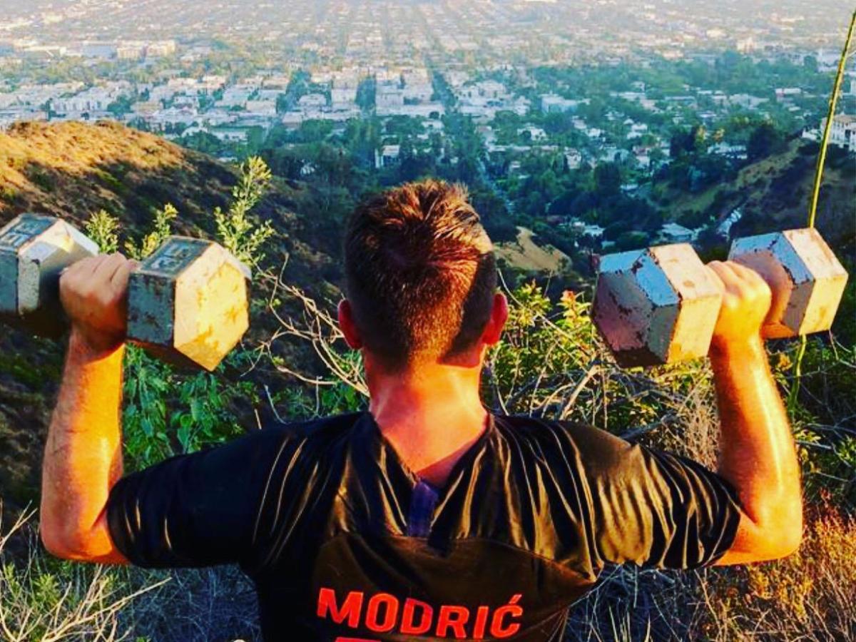 a man holding weights taking a hike