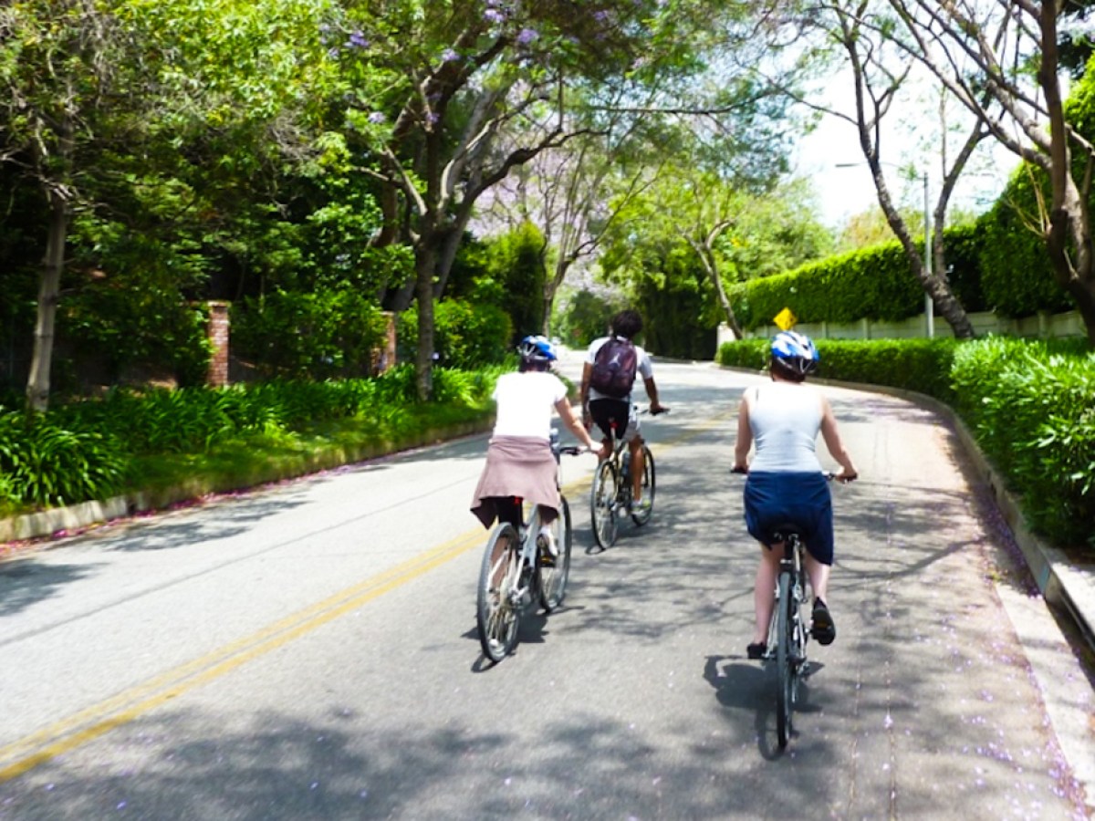 a person riding a bicycle down the street