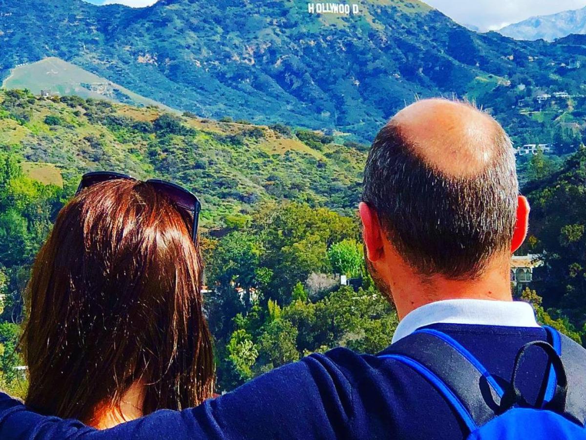 a man standing in front of a mountain