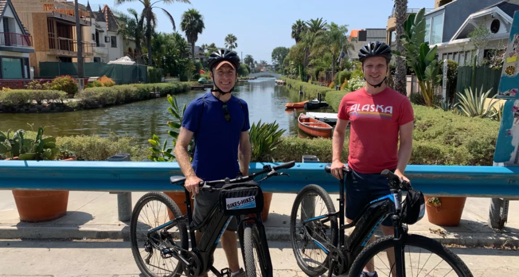 couple biking at the venice canals