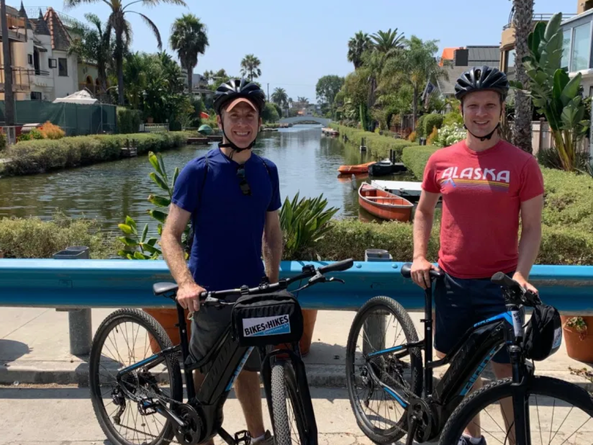couple biking at the venice canals