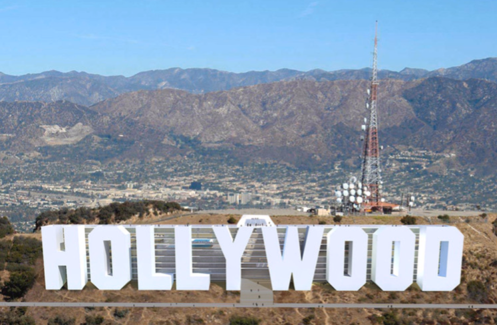 a large mountain in the background with Hollywood Sign in the background