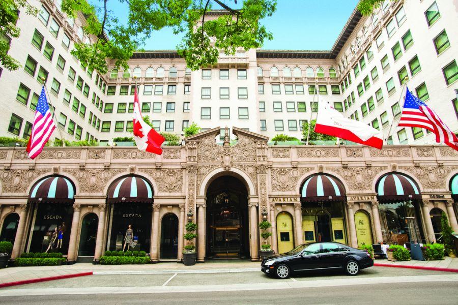 a close up of a street in front of Beverly Wilshire Hotel