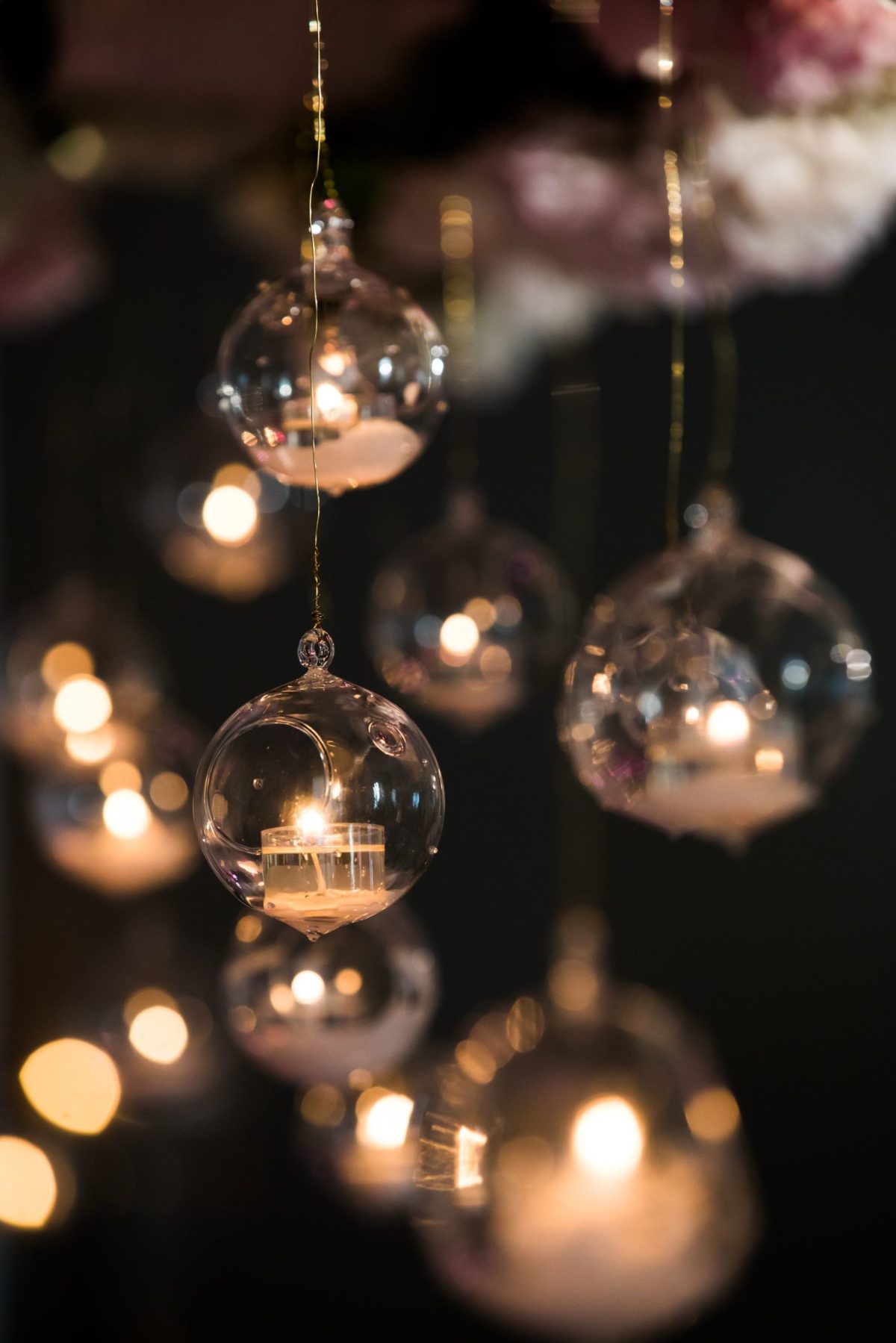 rose gold lights a group of people sitting at a table with wine glasses