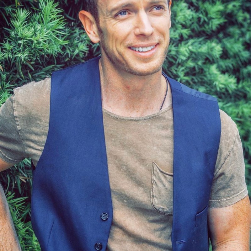 Matthew Bellows wearing glasses and smiling at the camera