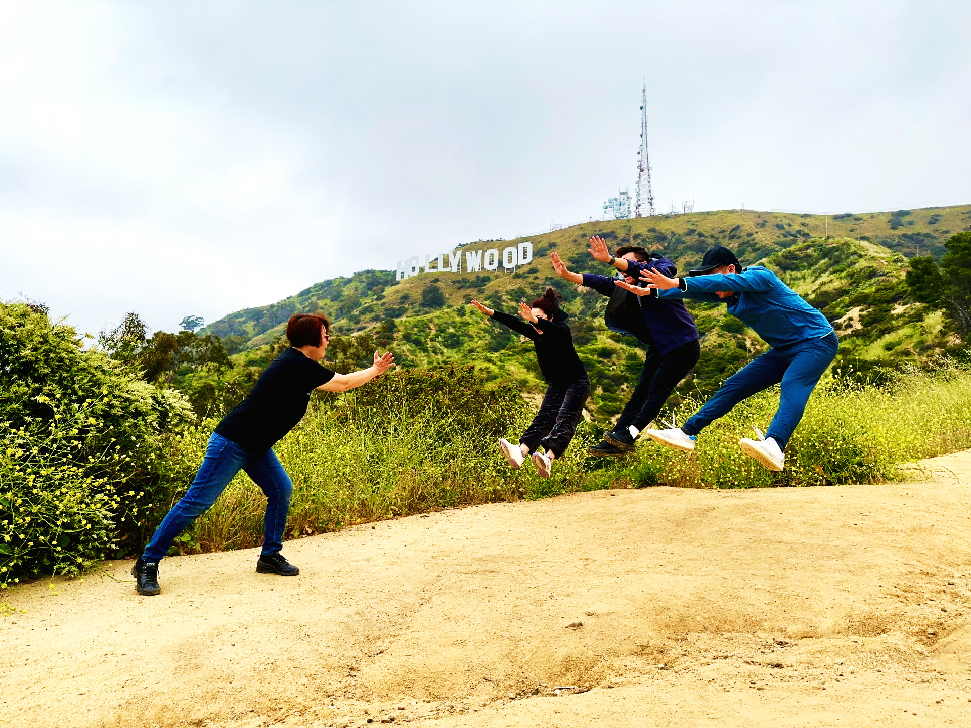 a group of people walking down a dirt road