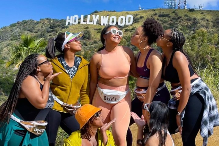 a group of people that are standing in the grass