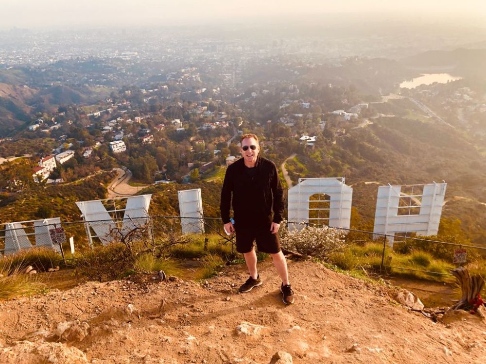 a man standing in front of a mountain