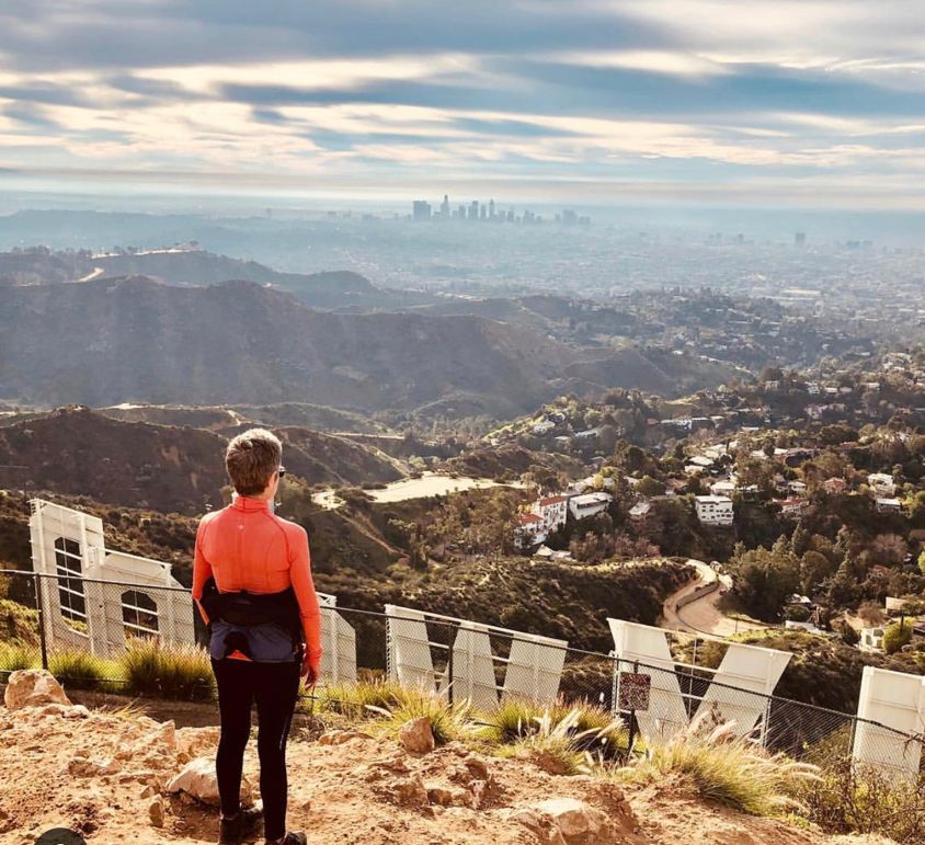a man standing in front of a mountain