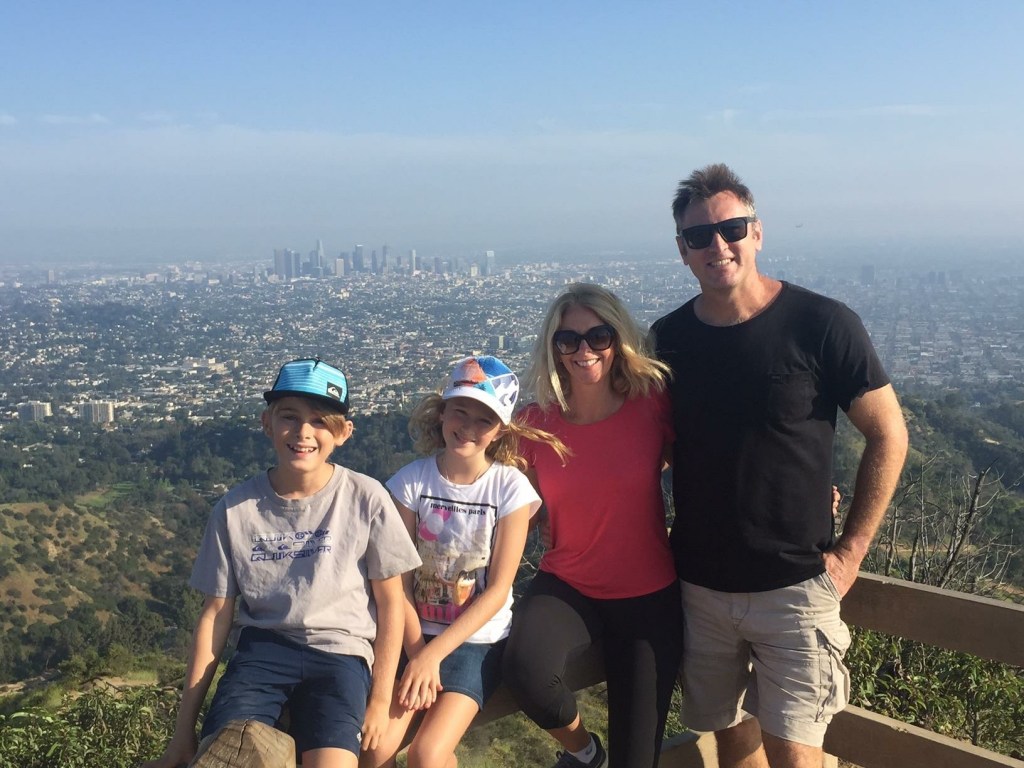 a man and woman sitting next to a body of water