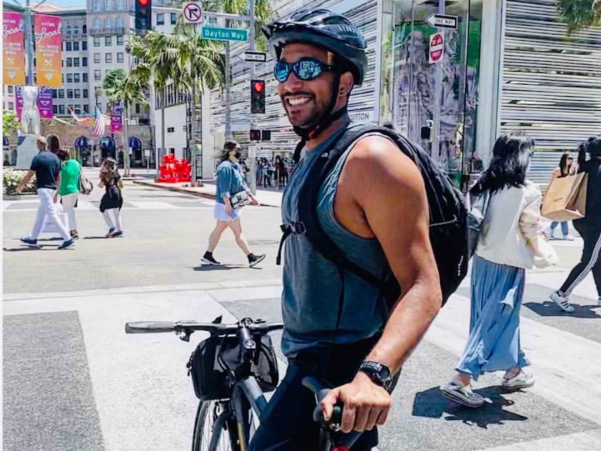 a person riding a bicycle on a city street in Los Angeles