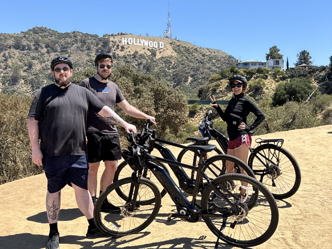 Hollywood Sign Bike Tour with Guests standing in front of the sign