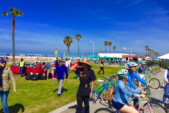 a group of people riding on the back of a bicycle