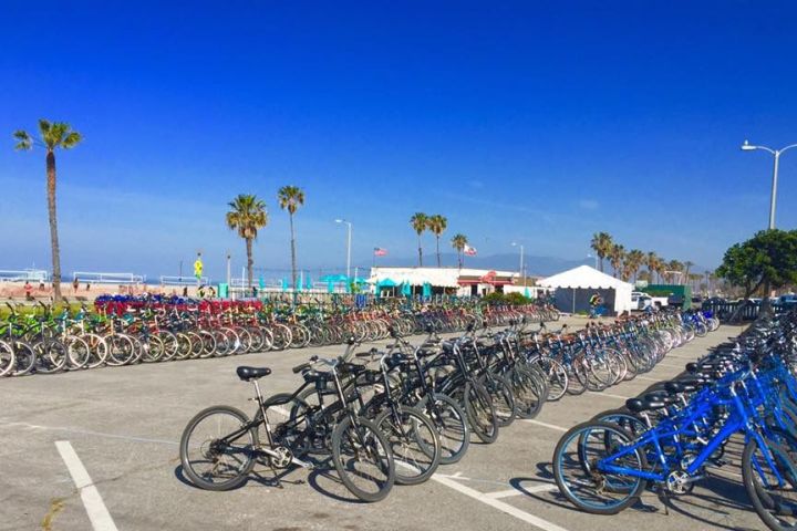 a row of motorcycles parked in a parking lot