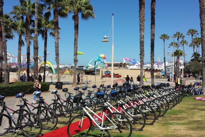 a group of people standing in front of a bicycle
