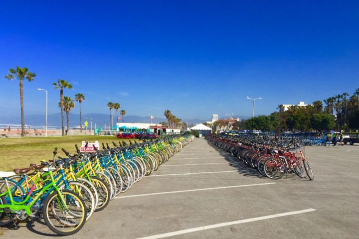 a row of parked motorcycles sitting in a parking lot