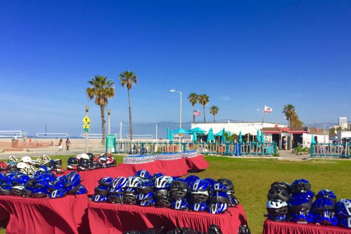 a row of parked motorcycles sitting on top of a grass covered field