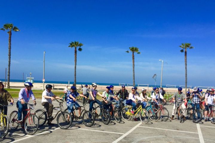 a group of people riding on the back of a bicycle