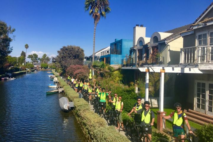 a group of people on a bridge over water