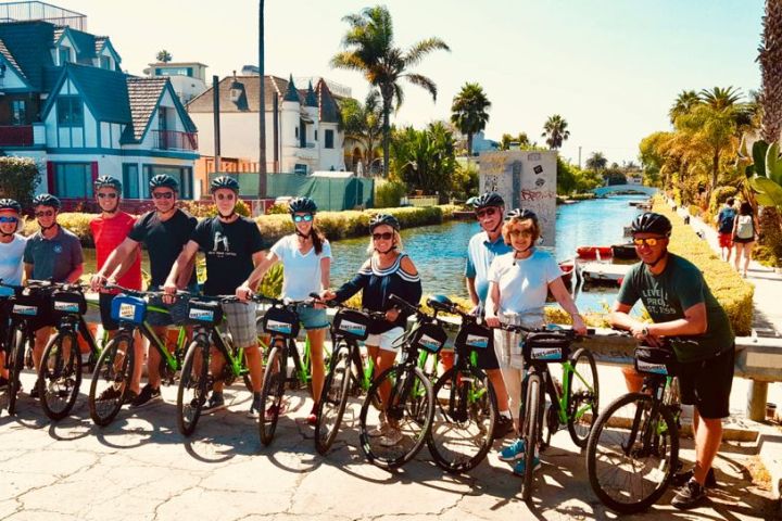 a group of people riding on the back of a bicycle