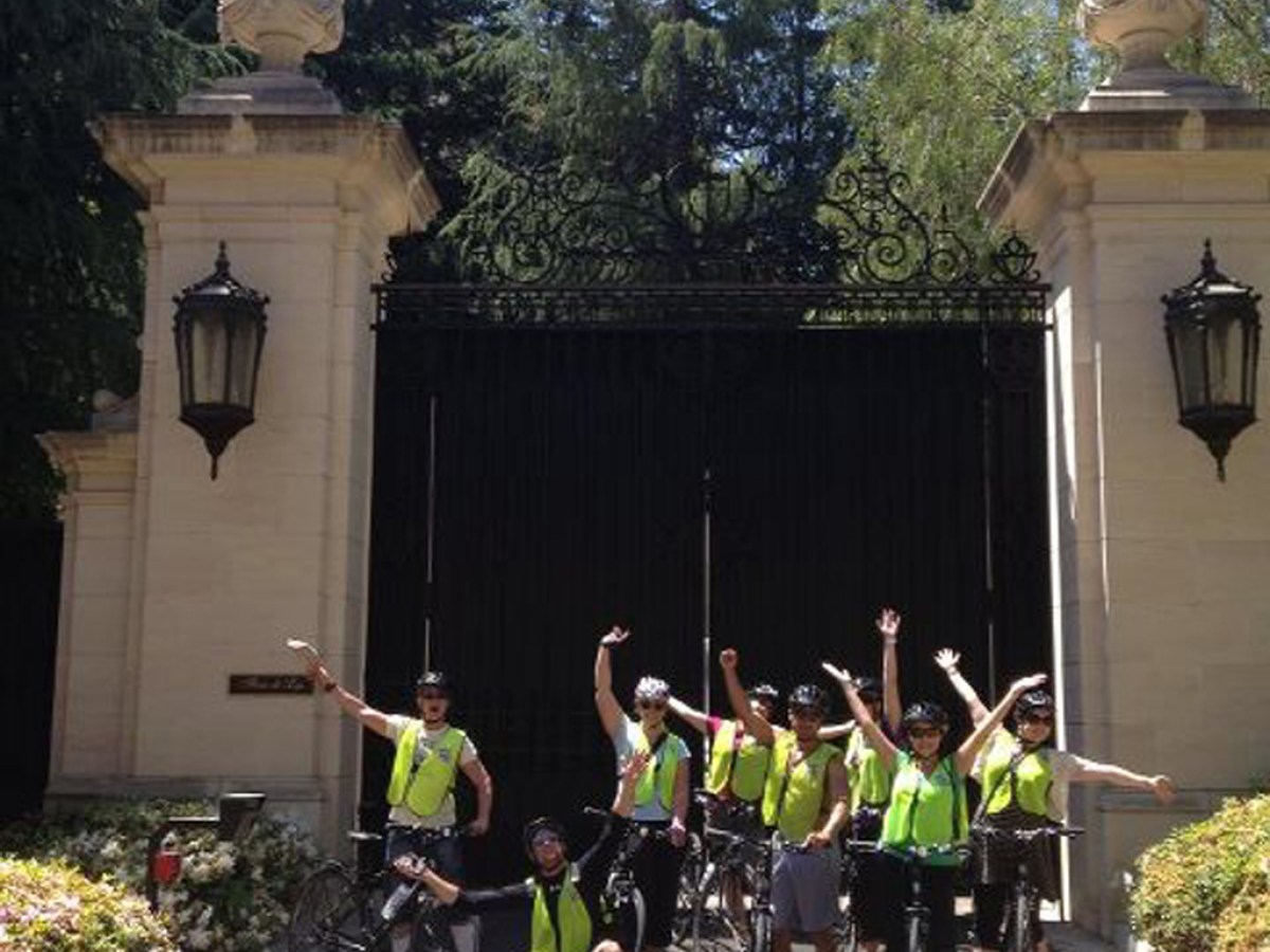 a group of people riding on the back of a bicycle