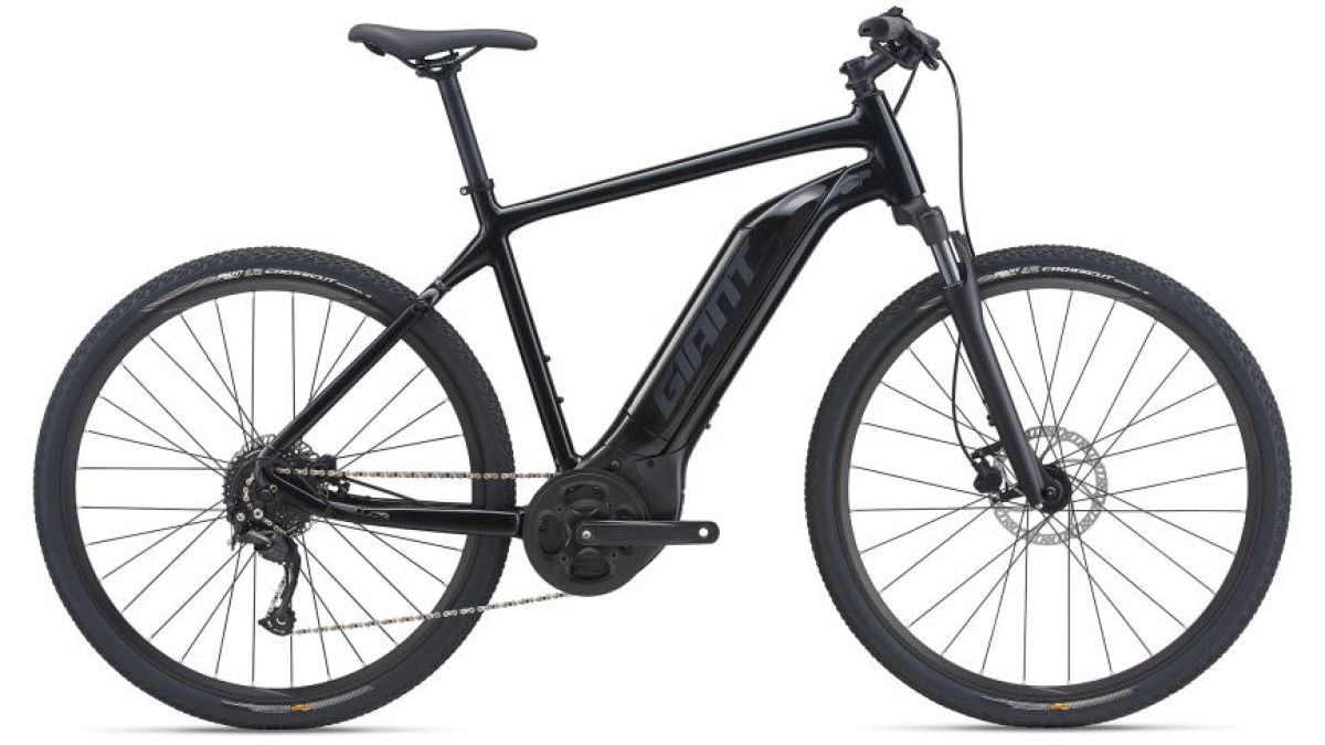 Giant Roam E+ GTS BLACK a bicycle leaning against a wall