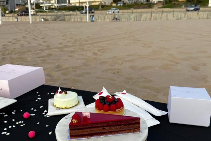 A slice of cake on a table at a beach