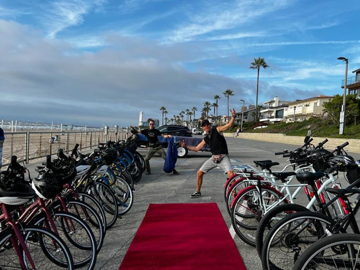 A group of bicycles by a red carpet on a boardwalk